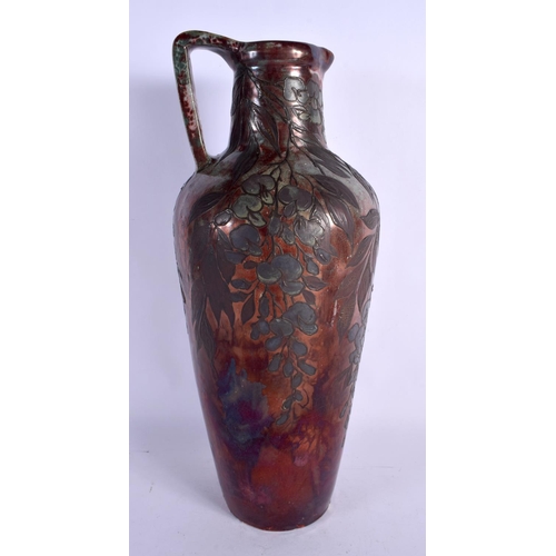 405 - A LARGE ART NOUVEAU FRENCH POTTERY EWER overlaid with trailing berries and vines. 40 cm x 15 cm.