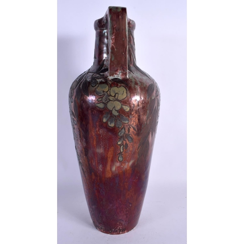 405 - A LARGE ART NOUVEAU FRENCH POTTERY EWER overlaid with trailing berries and vines. 40 cm x 15 cm.