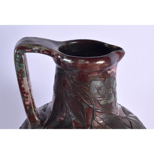 405 - A LARGE ART NOUVEAU FRENCH POTTERY EWER overlaid with trailing berries and vines. 40 cm x 15 cm.