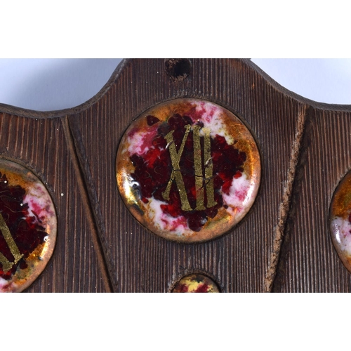 408 - A VERY RARE EARLY 20TH CENTURY CARVED WOOD AND ENAMEL MANTEL CLOCK set with numerous roundels. 34 cm... 