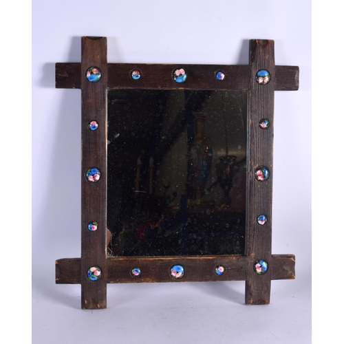 409 - A VERY SIMILAR EARLY 20TH CENTURY CARVED WOOD AND ENAMEL MIRROR inset with numerous roundels. 42 cm ... 