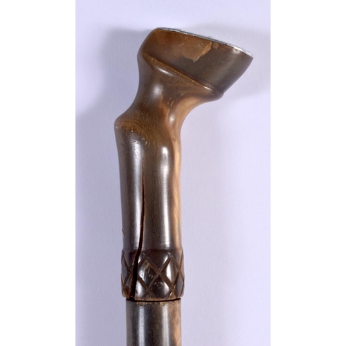 415 - A 19TH CENTURY MIDDLE EASTERN CARVED RHINOCEROS HORN SHOE HORN SWAGGER STICK with hoof terminal. 60 ... 
