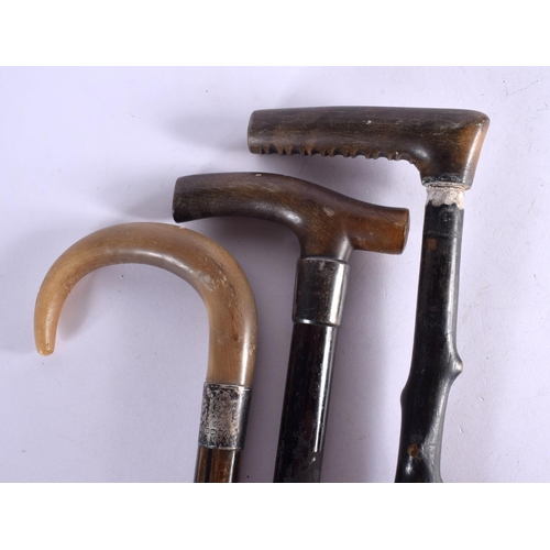 418 - THREE 19TH CENTURY MIDDLE EASTERN CARVED RHINOCEROS HORN WALKING CANES. 90 cm long. (3)