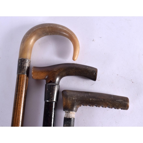 418 - THREE 19TH CENTURY MIDDLE EASTERN CARVED RHINOCEROS HORN WALKING CANES. 90 cm long. (3)