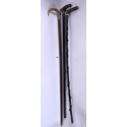 418 - THREE 19TH CENTURY MIDDLE EASTERN CARVED RHINOCEROS HORN WALKING CANES. 90 cm long. (3)