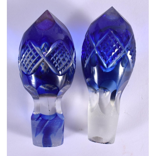 57 - A PAIR OF BOHEMIAN BLUE FLASH DECANTERS with stoppers  together with a vase & bells. Largest 34 cm h... 