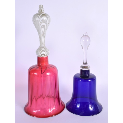 57 - A PAIR OF BOHEMIAN BLUE FLASH DECANTERS with stoppers  together with a vase & bells. Largest 34 cm h... 