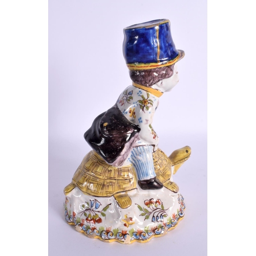 109 - A RARE EARLY 20TH CENTURY FRENCH TIN GLAZED FAIENCE BELL modelled as a boy riding a tortoise. 17 cm ... 