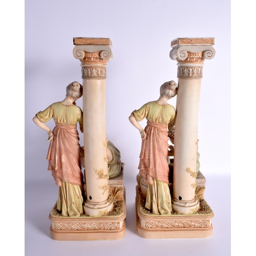 115 - A LARGE PAIR OF AUSTRIAN ROYAL DUX BISQUE PORCELAIN CANDLESTICKS. 42 cm x 15 cm.