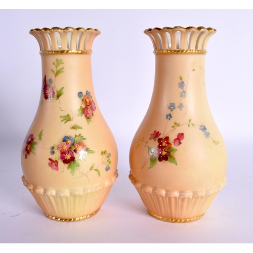 135 - Royal Worcester pair of pierced neck vases shape G1061 painted with flowers on a blush ivory ground ... 