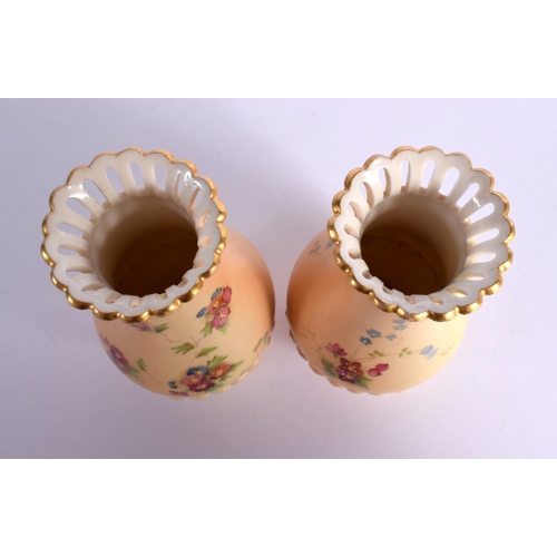 135 - Royal Worcester pair of pierced neck vases shape G1061 painted with flowers on a blush ivory ground ... 