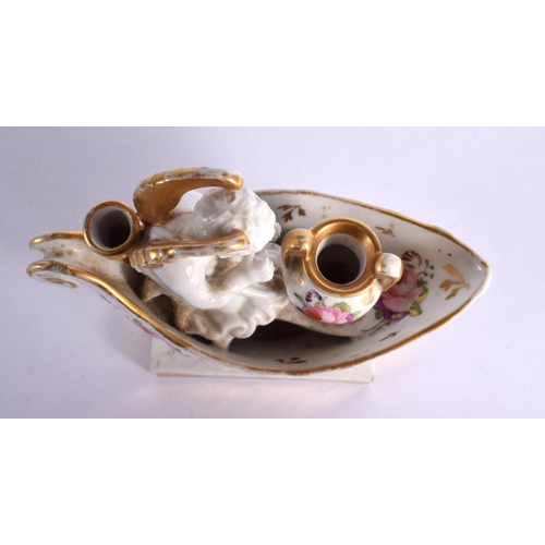 183 - 19th century Paris porcelain inkwell modelled with a winged cherub seated before a two handled vase ... 