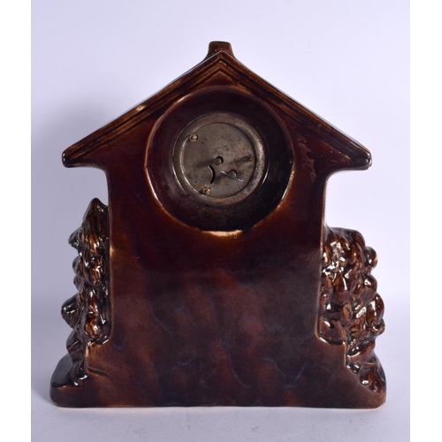 22 - AN UNUSUAL TREACLE GLAZED POTTERY STAG CLOCK. 29 cm x 22 cm.