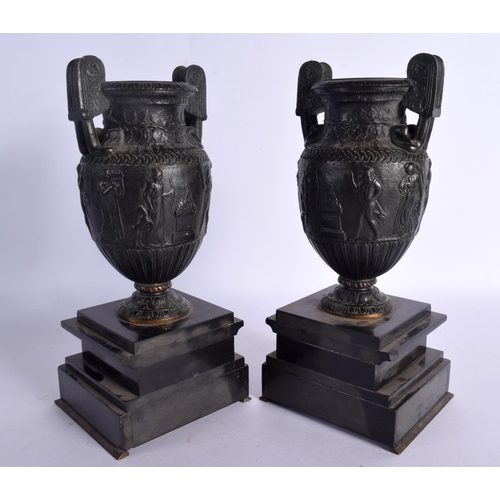 256 - A PAIR OF 19TH CENTURY EUROPEAN GRAND TOUR BRONZE URNS upon marble bases. 29 cm high.