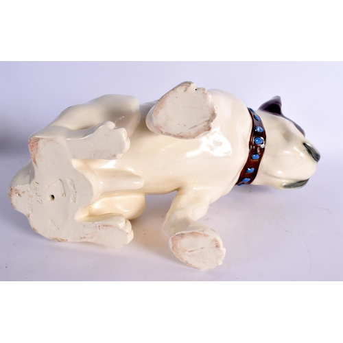 28 - A LARGE ART DECO AUSTRIAN FIGURE OF A DOG modelled recumbent 26 cm x 21 cm.