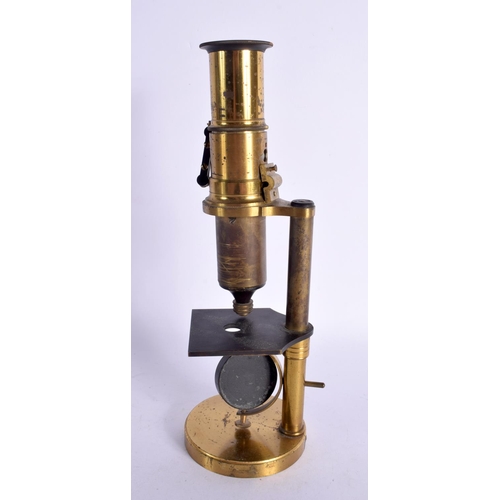 299 - A VINTAGE BRASS MICROSCOPE. 24 cm high.