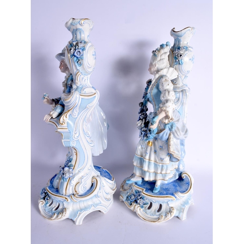 63 - A GOOD LARGE PAIR OF 19TH CENTURY GERMAN BLUE AND WHITE PORCELAIN FIGURES modelled as a female and f... 