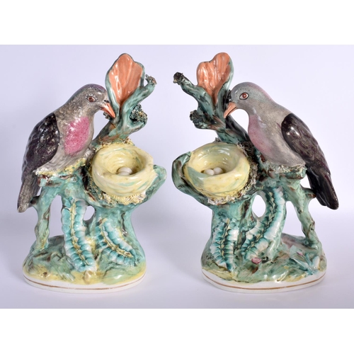 67 - A RARE PAIR OF 19TH CENTURY STAFFORDSHIRE FIGURES OF DOVES modelled beside nests. 24 cm x 12 cm.