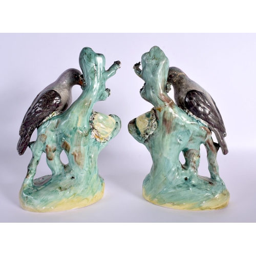 67 - A RARE PAIR OF 19TH CENTURY STAFFORDSHIRE FIGURES OF DOVES modelled beside nests. 24 cm x 12 cm.