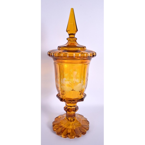 69 - A LARGE LIDDED BOHEMIAN ETCHED AMBER GLASS VASE etched panels of deer & horses. 37 cm high.