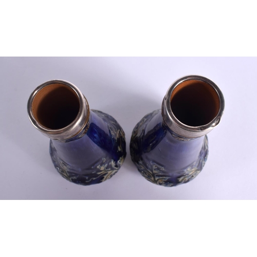 87 - A PAIR OF ANTIQUE SILVER MOUNTED ROYAL DOULTON VASES. 16.5 cm high.