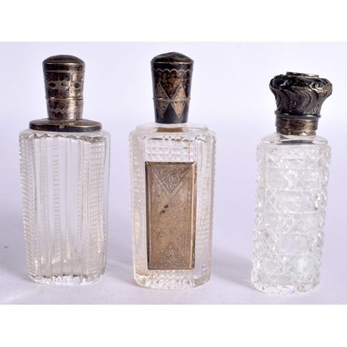 1095 - THREE SILVER TOPPED SCENT BOTTLES.  Largest 9cm x 3.3cm x 2.3cm (3)