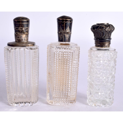 1095 - THREE SILVER TOPPED SCENT BOTTLES.  Largest 9cm x 3.3cm x 2.3cm (3)