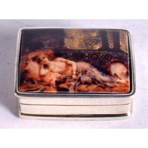 1096 - A SILVER PILL BOX WITH A SCANTILY CLAD WOMAN ON THE LID.  Stamped 925, 1.3cm x 2.6cm x 3.2cm, weight... 