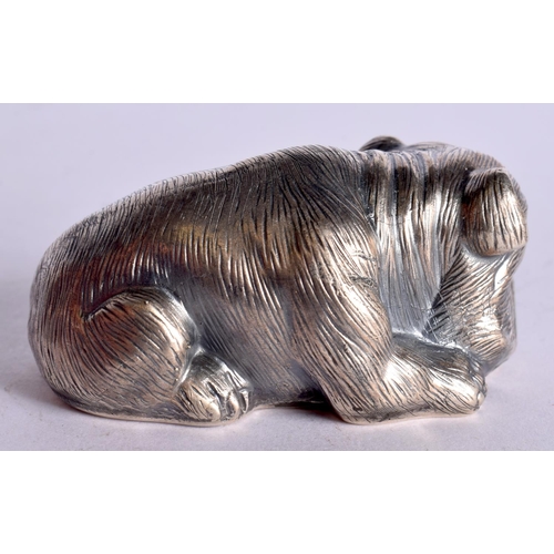 1102 - A CONTINENTAL SILVER MODEL OF A SEATED DOG WITH GEM SET EYES.  Stamped 84, 3.1cm x 6.6cm x 3.4cm, we... 