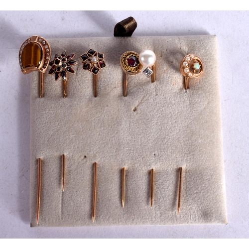 1106 - SIX ASSORTED JEWEL ENCRUSTED GOLD STICK PINS.  6.7cm long, total weight 7.1g (6)