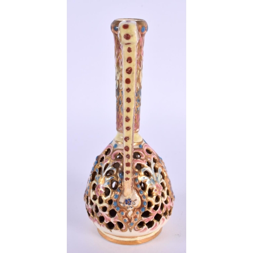 103 - A HUNGARIAN FAIENCE RETICULATED ZSOLNAY TYPE EWER. 14 cm high.