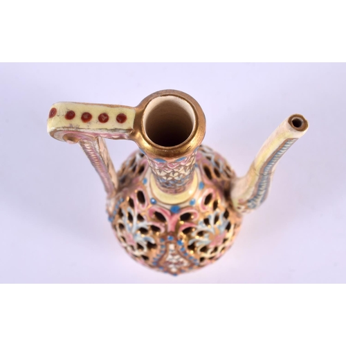 103 - A HUNGARIAN FAIENCE RETICULATED ZSOLNAY TYPE EWER. 14 cm high.