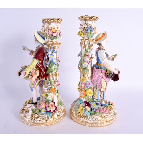 220 - 19th century pair of Minton figures of a boy and girl standing before a candlestick, the bases encru... 