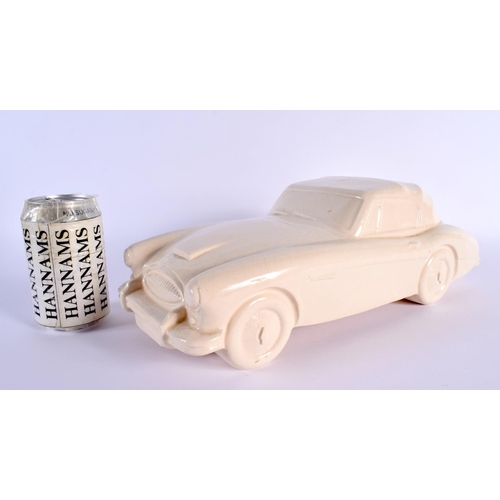 24 - A CHARMING BRISTOL POTTERY MODEL OF A VINTAGE CAR by Ted Eric Wayman. 37 cm wide.