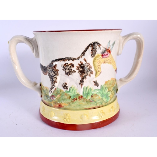 266 - A 19TH CENTURY ENGLISH TWIN HANDLED FROG MUG decorated with dogs and game. 21 cm wide.