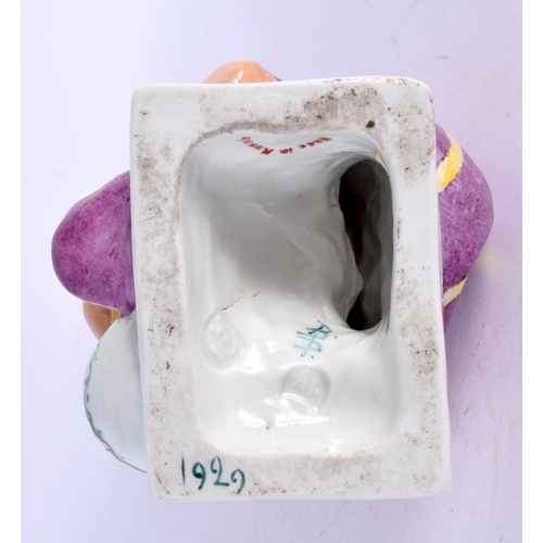 276 - A RARE RUSSIAN PORCELAIN FIGURE OF A SEATED FEMALE modelled washing clothes. 15 cm x 8 cm.