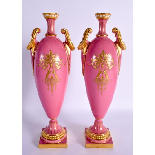 29 - A FINE PAIR OF 19TH CENTURY ROYAL WORCESTER TWIN HANDLED PINK GROUND VASES by Harry Davis, painted w... 