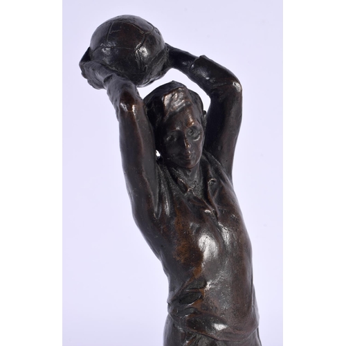 291C - A RARE 1940S BRONZE FIGURE OF A FOOTBALL PLAYER modelled upon an oak plinth. 24 cm high.