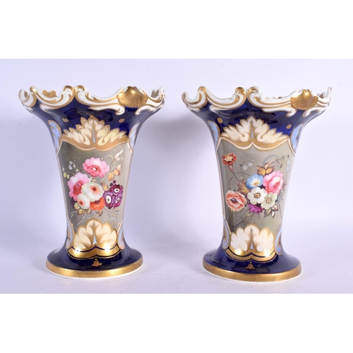 294D - A PAIR OF MID 19TH CENTURY ENGLISH PORCELAIN FLUTED VASES painted with flowers upon a blue ground. 1... 