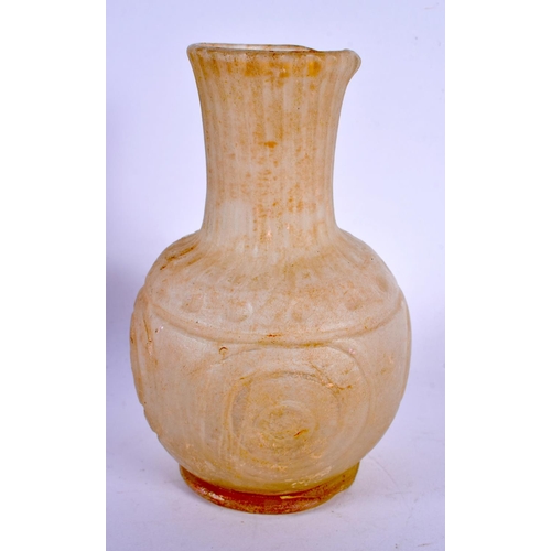 298E - AN EARLY MIDDLE EASTERN ISLAMIC GLASS JAR. 14 cm high.