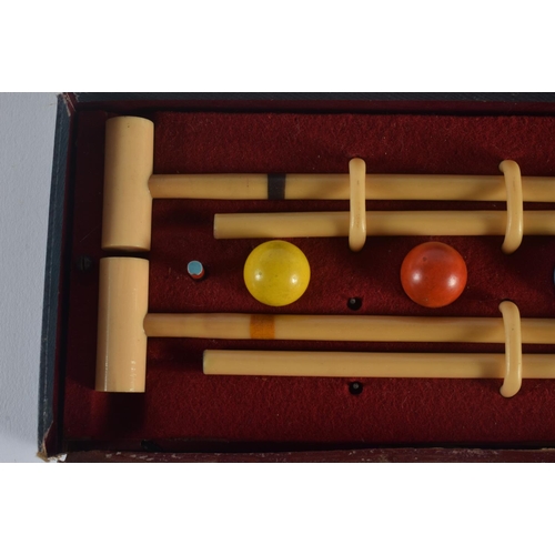 303 - A CHARMING BUSSEYS TABLE CROQUET SET. Box 26 cm x 12 cm.