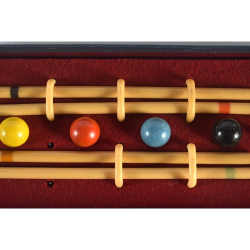 303 - A CHARMING BUSSEYS TABLE CROQUET SET. Box 26 cm x 12 cm.