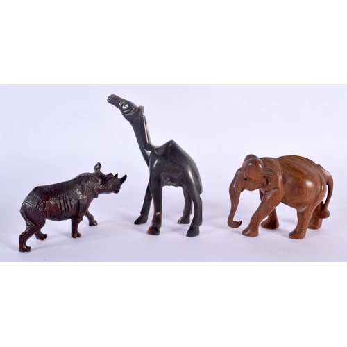 315 - AN ANTIQUE MIDDLE EASTERN CARVED RHINOCEROS HORN FIGURE OF A CAMEL together with two treen animals. ... 