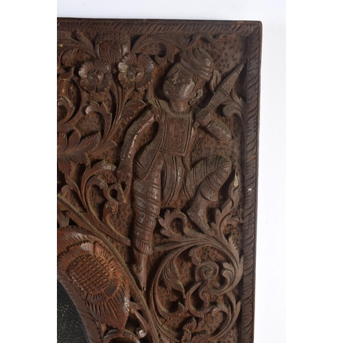 320 - AN EARLY 20TH CENTURY INDO THAI CARVED WOOD BURMESE TYPE MIRROR decorated with beasts and hunters. 5... 