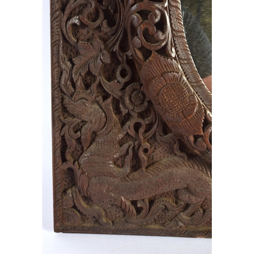 320 - AN EARLY 20TH CENTURY INDO THAI CARVED WOOD BURMESE TYPE MIRROR decorated with beasts and hunters. 5... 