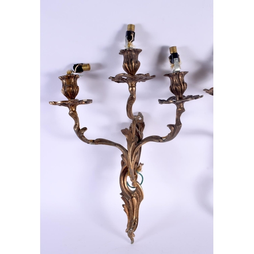 323 - A PAIR OF VINTAGE COUNTRY HOUSE GILT METAL TRIPLE BRANCH CANDLE WALL SCONCES. 46 cm x 24 cm.