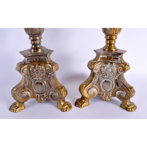 324 - A LARGE PAIR OF ANTIQUE CONTINENTAL BRASS CANDLESTICKS. 58 cm high.