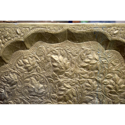 325 - A LARGE EARLY 20TH CENTURY INDIAN EMBOSSED BRASS PANEL depicting figures. 118 cm x 52 cm.