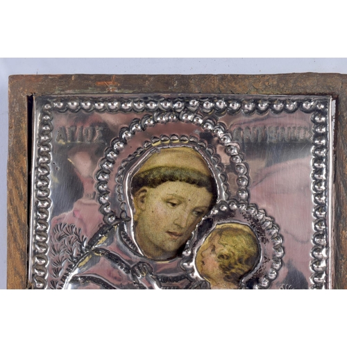 328 - A RUSSIAN SILVER MOUNTED WOOD ICON. 18 cm x 14 cm.