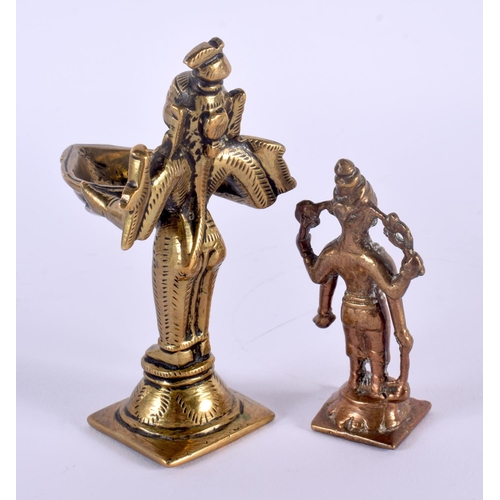 334 - AN 18TH CENTURY INDIAN BRONZE FIGURE OF A BUDDHISTIC DEITY modelled holding an oil burner, together ... 